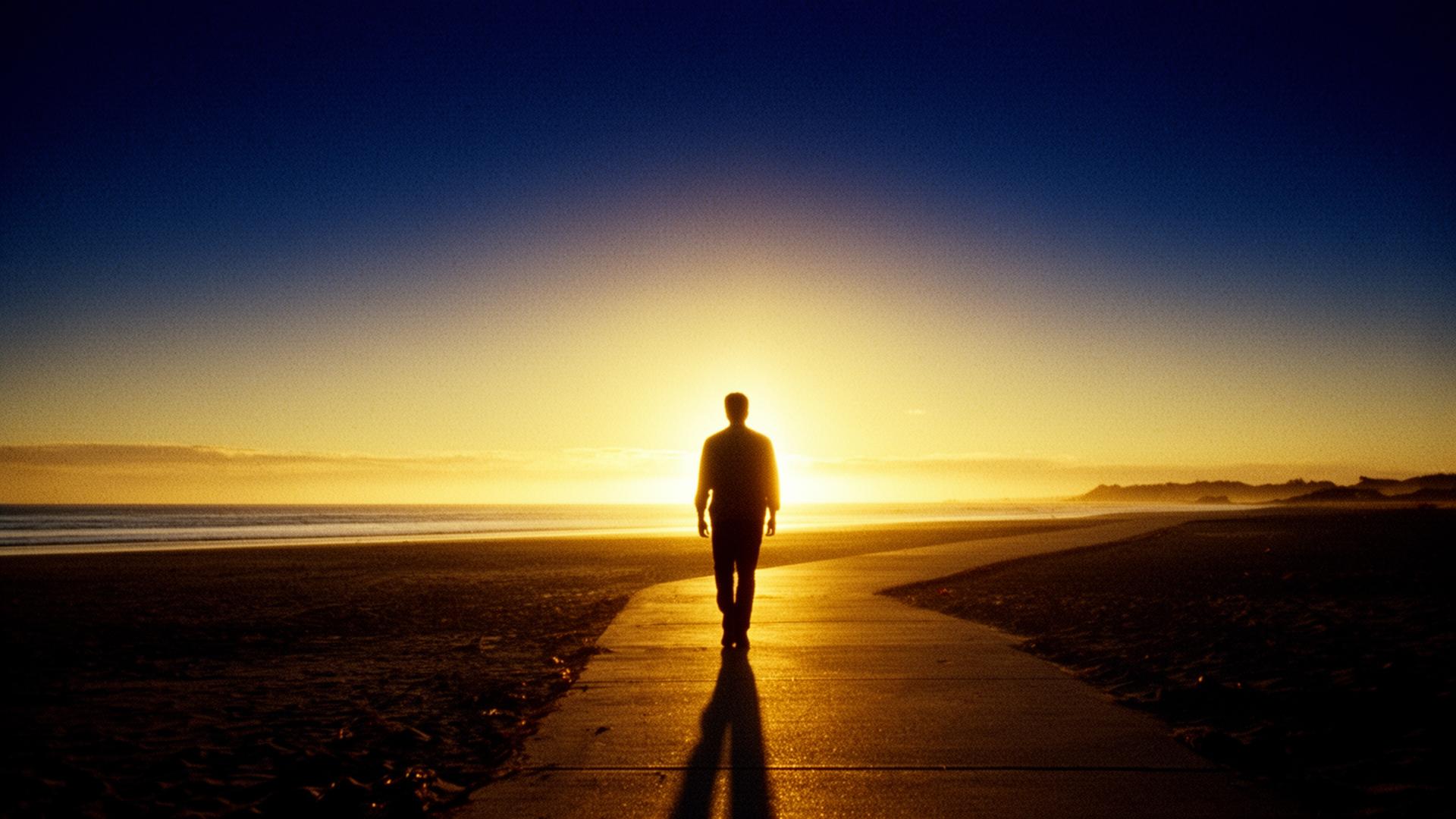 A person walking toward the sunrise — a new beginning